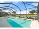 A screened-in pool boasts tranquil water and peaceful views of the lake at 14309 Carolina Sky Pl, Lakewood Ranch, FL 34211