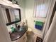 Clean bathroom with granite countertop, basin sink, medicine cabinet and updated fixtures at 1438 Vermouth Ln, Punta Gorda, FL 33983