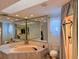 Spacious bathroom features a vanity, large mirrors, tiled shower, and a separate tub for relaxation at 1438 Vermouth Ln, Punta Gorda, FL 33983