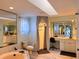 Well-lit bathroom boasts a vanity, tub, shower, and skylight offering a serene and spa-like experience at 1438 Vermouth Ln, Punta Gorda, FL 33983