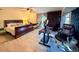 Bright bedroom featuring a bed, hammock, desk area with monitors, ceiling fan, and view of the outdoors at 1438 Vermouth Ln, Punta Gorda, FL 33983