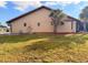 Side view of home featuring well-kept lawn, privacy landscaping, and pest control screens at 1438 Vermouth Ln, Punta Gorda, FL 33983