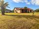 Charming home exterior with stucco and stone, a clay tile roof, a well-manicured lawn and mature landscaping at 1438 Vermouth Ln, Punta Gorda, FL 33983