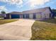 Charming single-story home with well-kept lawn, mature trees, and a private two-car garage at 1438 Vermouth Ln, Punta Gorda, FL 33983