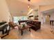Open concept living room with a pool table, soaring ceilings and a view to the wet bar at 1438 Vermouth Ln, Punta Gorda, FL 33983