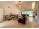 Bright living room with tile floors, soaring ceilings and a pool table next to sliding glass doors at 1438 Vermouth Ln, Punta Gorda, FL 33983