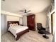 Spacious main bedroom with a ceiling fan, dark hardwood floors and an armoire at 1438 Vermouth Ln, Punta Gorda, FL 33983