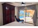 Main bedroom featuring hardwood floors, a sitting area and a view to the pool at 1438 Vermouth Ln, Punta Gorda, FL 33983