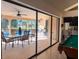 View from inside to the outdoor living area, pool, bar and grill at 1438 Vermouth Ln, Punta Gorda, FL 33983