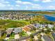 Aerial view of home with lush lawn in community featuring lakes and recreational areas at 1717 Bonita Bluff Ct, Ruskin, FL 33570