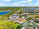Aerial view showcases home with brown roof, well-manicured lawn, and community pond at 1717 Bonita Bluff Ct, Ruskin, FL 33570