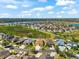 Aerial view of home in a suburban neighborhood with a scenic lake in the background at 1717 Bonita Bluff Ct, Ruskin, FL 33570