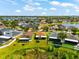 Aerial view showcases home with adjacent pond, well-manicured lawn, and screen patio at 1717 Bonita Bluff Ct, Ruskin, FL 33570
