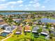 Aerial view of a single-Gathering home featuring a well-maintained lawn in a lakeside community at 1717 Bonita Bluff Ct, Ruskin, FL 33570
