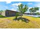 Well-maintained backyard featuring a screened lanai and lush green lawn at 1717 Bonita Bluff Ct, Ruskin, FL 33570