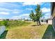 Backyard featuring well-maintained landscaping and a scenic view of a retention pond at 1717 Bonita Bluff Ct, Ruskin, FL 33570