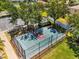 Aerial view of fenced basketball court in community; landscaping, trees, and walking path at 1717 Bonita Bluff Ct, Ruskin, FL 33570