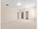 Expansive bedroom with carpet flooring and two doorways, providing ample space at 1717 Bonita Bluff Ct, Ruskin, FL 33570