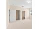 Carpeted bedroom with two doorways to the ensuite bath and walk-in closet at 1717 Bonita Bluff Ct, Ruskin, FL 33570