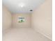Neutral bedroom with neutral walls and carpeting, and natural light from the window at 1717 Bonita Bluff Ct, Ruskin, FL 33570