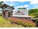 Community sign with stone accents surrounded by vibrant flower beds at 1717 Bonita Bluff Ct, Ruskin, FL 33570