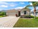 Well-kept home with neutral tones, stone accents, a two-car garage, and an attractive brick walkway at 1717 Bonita Bluff Ct, Ruskin, FL 33570