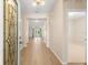 Elegant foyer with decorative glass door, hardwood floors, and a view into the living area at 1717 Bonita Bluff Ct, Ruskin, FL 33570