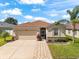 Charming single-story home with a well-manicured lawn and attached two-car garage at 1717 Bonita Bluff Ct, Ruskin, FL 33570