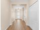 Inviting hallway with wood-look tile flooring leading to a decorative glass front door at 1717 Bonita Bluff Ct, Ruskin, FL 33570