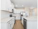 Well-lit kitchen with white cabinets, granite countertops, and stainless steel appliances at 1717 Bonita Bluff Ct, Ruskin, FL 33570