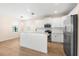 Modern kitchen with white cabinets, stainless appliances, granite counters, and breakfast bar at 1717 Bonita Bluff Ct, Ruskin, FL 33570