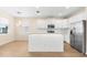 Bright, open kitchen featuring white cabinetry, stainless appliances, and a central island at 1717 Bonita Bluff Ct, Ruskin, FL 33570