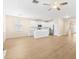 Spacious living area with hardwood floors, modern lighting, and an open flow to the kitchen at 1717 Bonita Bluff Ct, Ruskin, FL 33570