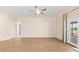 Bright living room with wood-look flooring, ceiling fan, and glass doors to the outside at 1717 Bonita Bluff Ct, Ruskin, FL 33570