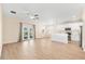 Open-concept living and kitchen area with hardwood floors, modern appliances, and ample natural light at 1717 Bonita Bluff Ct, Ruskin, FL 33570