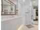 This bathroom features a marble countertop, a shower with glass door and a large mirror at 1720 Kestral Park S Way # 49, Sarasota, FL 34231