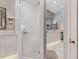 This bathroom features a shower with glass door, double sinks and marble countertops at 1720 Kestral Park S Way # 49, Sarasota, FL 34231