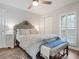 Bright bedroom featuring a comfortable bed, light gray walls, a ceiling fan and plantation shutters at 1720 Kestral Park S Way # 49, Sarasota, FL 34231