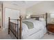This bedroom features a metal bed frame and closet at 1720 Kestral Park S Way # 49, Sarasota, FL 34231
