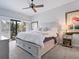 This bedroom features a large bed, sliding doors to a patio, and elegant decor at 1720 Kestral Park S Way # 49, Sarasota, FL 34231