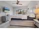 This bedroom features a large bed, a ceiling fan, and elegant decor at 1720 Kestral Park S Way # 49, Sarasota, FL 34231