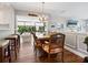 Dining room adjacent to kitchen with a hardwood table, ornate chairs, and bright chandelier at 1720 Kestral Park S Way # 49, Sarasota, FL 34231