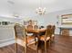 Traditional dining room with hardwood table, ornate chairs, and a decorative ceiling at 1720 Kestral Park S Way # 49, Sarasota, FL 34231