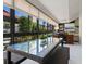 Florida room featuring many windows, a ceiling fan, dining and work space, and view to a living area at 1720 Kestral Park S Way # 49, Sarasota, FL 34231