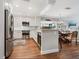 Updated kitchen with stainless steel appliances, white cabinetry, a breakfast bar and an adjacent dining area at 1720 Kestral Park S Way # 49, Sarasota, FL 34231