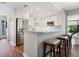 Bright kitchen with stainless steel refrigerator, bar seating, granite countertops, and recessed lighting at 1720 Kestral Park S Way # 49, Sarasota, FL 34231