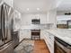 Updated kitchen featuring white cabinets, stainless steel appliances, subway tile backsplash, and granite countertops at 1720 Kestral Park S Way # 49, Sarasota, FL 34231