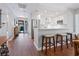 Open kitchen featuring stainless steel appliances, white cabinets, bar seating, and hardwood floors at 1720 Kestral Park S Way # 49, Sarasota, FL 34231