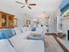 Spacious living room featuring a sectional sofa, fireplace, ceiling fan, and an open concept design at 1720 Kestral Park S Way # 49, Sarasota, FL 34231