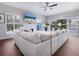 Bright living room featuring plantation shutters, a cozy fireplace, and a large sectional sofa at 1720 Kestral Park S Way # 49, Sarasota, FL 34231